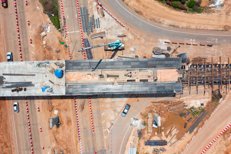 Aerial view of construction tractor car, bulldozer, or backhoe digging road or street in traffic transportation and agriculture concept. Engine working in urban city town.の写真素材