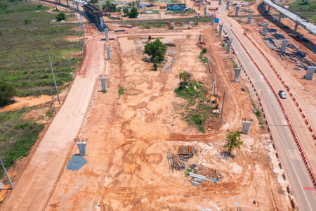 Aerial view of construction tractor car, bulldozer, or backhoe digging road or street in traffic transportation and agriculture concept. Engine working in urban city town.の写真素材