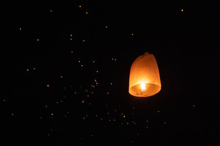 Thai people release sky floating lanterns or lamp to worship Buddha's relics at night. Traditional festival in Chiang mai, Thailand. Loy krathongの写真素材