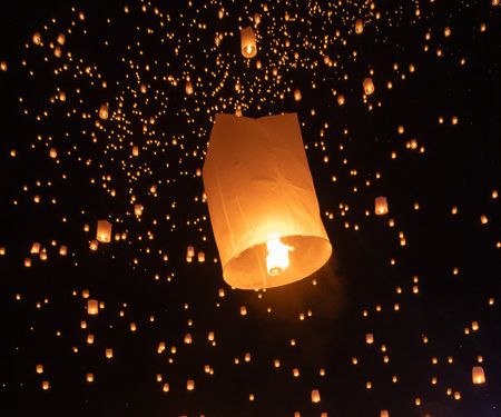 Thai people release sky floating lanterns or lamp to worship Buddha's relics at night. Traditional festival in Chiang mai, Thailand. Loy krathongの写真素材