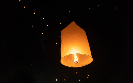 Thai people release sky floating lanterns or lamp to worship Buddha's relics at night. Traditional festival in Chiang mai, Thailand. Loy krathongの写真素材