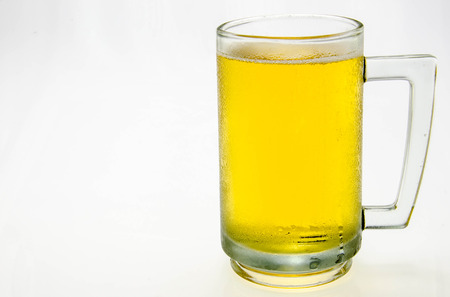 fresh beer with cap of foam isolated on white の写真素材