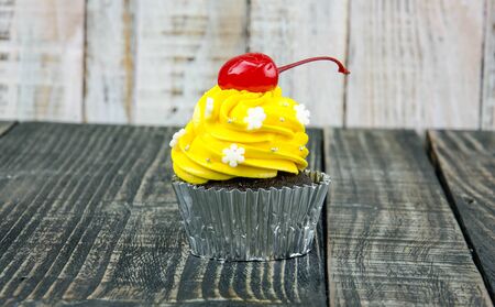 Colorful cupcakes on a wooden background