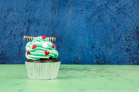 Colorful cupcakes on a wooden backgroundの写真素材