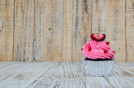 Colorful cupcakes on a wooden backgroundの写真素材