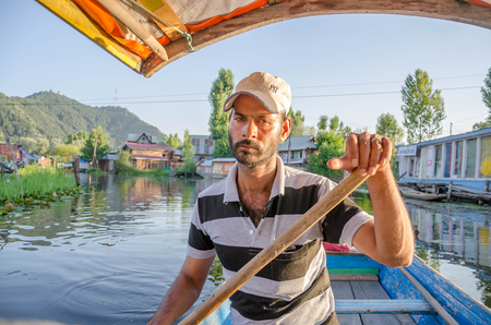 Srinagar, India - July 1, 2017 : Indian people. Indian Muslim man in boats on the dal lake in Srinagar, Jammu and Kashmir state, Indiaのeditorial素材