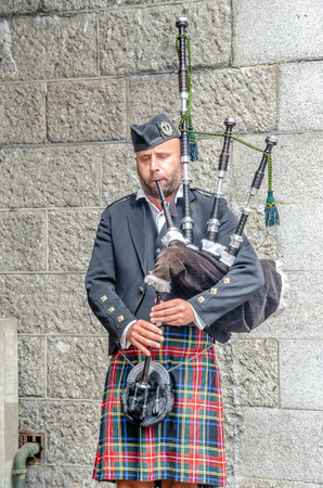 LONDON, UNITED KINGDOM - July 12, 2018 : Traditional scottish bagpiper in full dress code,London,United Kingdom.のeditorial素材