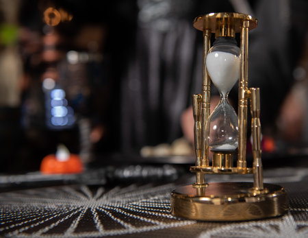 The hourglass is on the table. Photograph of a retro hourglass. Time.の写真素材