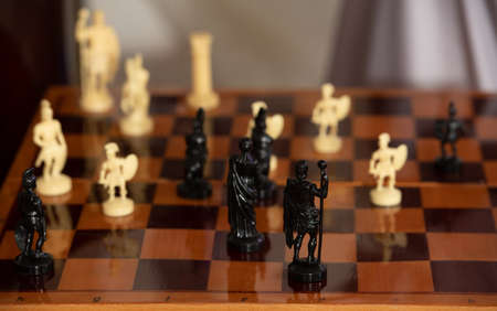 Chess game unusual figures in the form of people. Photo of a chessboard and chess. Intellectual...