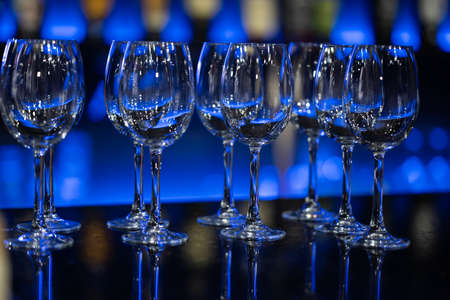 Empty wine glasses. Party, restaurant. Glasses for drinks in blue lighting.の写真素材