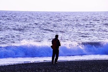 Winter beach fishermanの写真素材