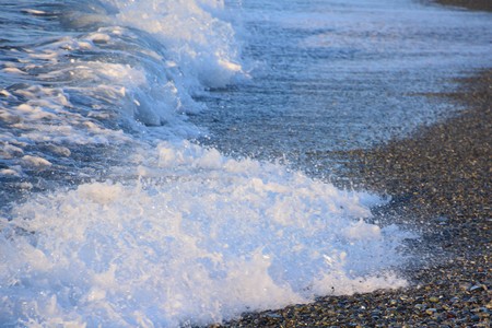 Ripples and waves crashing on rocksの写真素材