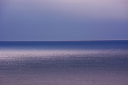 Reflection on the surface of the sea at dawnの写真素材