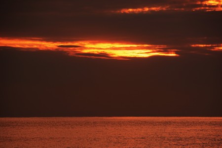 The sunrise is shining on the beachの写真素材