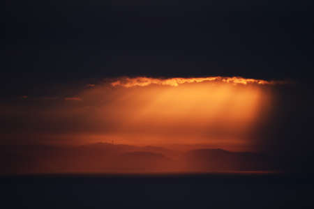 Angel âs ladder or Jacob's ladder. A natural phenomenon in which the sun shines through the clouds.の写真素材