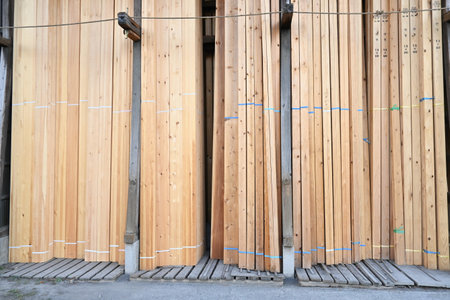 A view of the lumber shop. This lumber shop sells construction lumber, wood for DIY, wooden piles,firewood and birdhouses etc.の写真素材
