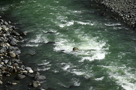A scene of splashing water in the river. Background material of the flow of river water.