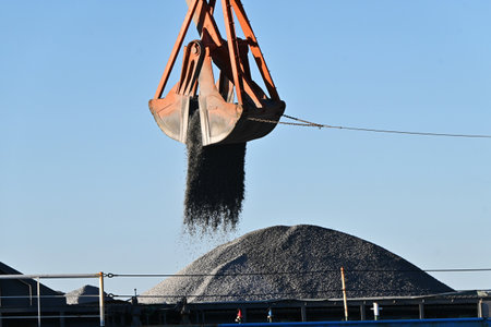 A scene of dredging work at the port. The purpose of dredging work is to scoop up sediment from the...