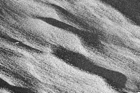 Ripple marks (wind ripples) on the sandy beach. Strong winds create artistic patterns in the sand.の写真素材