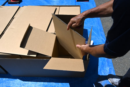 Disaster prevention drill. Assembling a cardboard bed for evacuation shelters. The floor of the evacuation shelter is hard and cold, so this bed allows get a good night's sleep.の写真素材