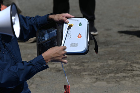 Lifesaving training using an AED. It is effective in helping the heart regain normal function by delivering an electric shock to the heart from outside the body.の写真素材