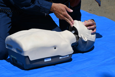 Lifesaving training using an AED. It is effective in helping the heart regain normal function by delivering an electric shock to the heart from outside the body.の写真素材