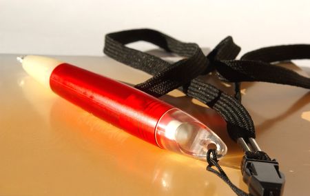 orange notebook and red penの写真素材