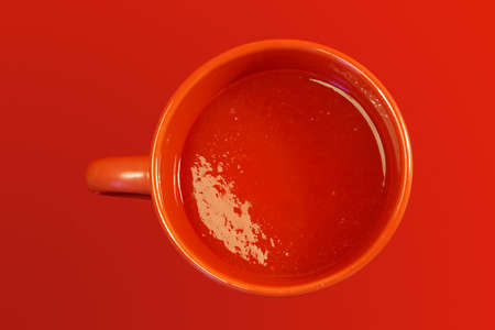 cup of tomato juice on red backgroundの写真素材