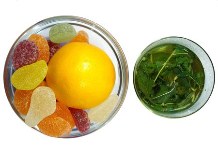 herbal  mint tea and  fruit candy on white background
