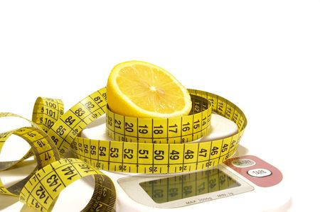 Lemon and tape measure on scale isolatedの写真素材
