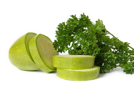 Raw cut zucchin and parsley isolated on white backgroundの写真素材