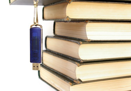 Books stack and flash memory isolated on whiteの写真素材