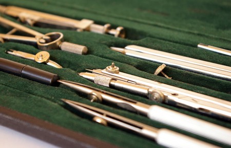 Professional case of drawing instruments on white