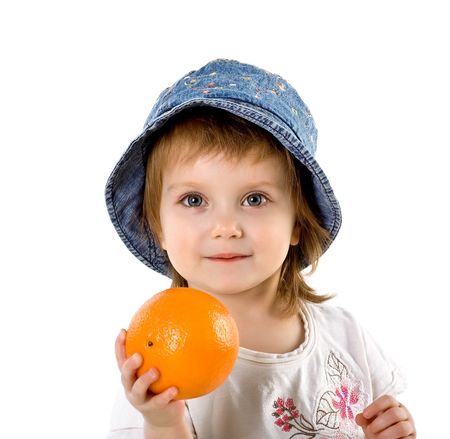 Cute little girl with orange isolated on white backgroundの写真素材
