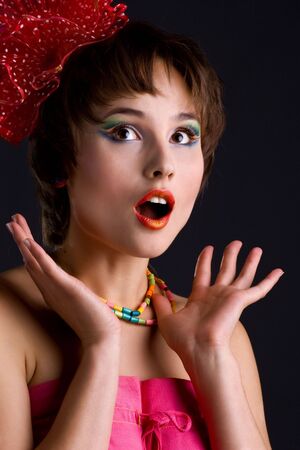 Cute woman with red bow on black backgroundの写真素材
