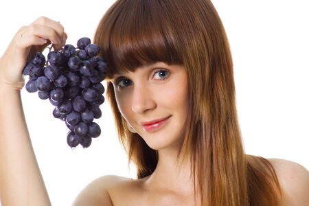 Cute women with a grapes on a white backgroundの写真素材