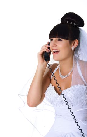 Pretty bride speaks on the phone. Studio shotの写真素材