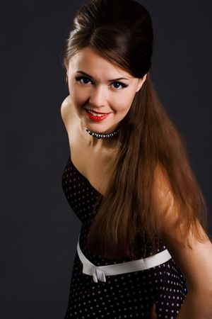 Beautyful girl in retro dress on a black backgroundの写真素材
