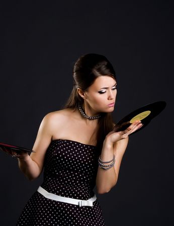 Pretty woman with gramophone record. Studio shotの写真素材