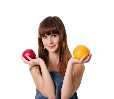 Pretty woman hold apple and orange. Studio shotの写真素材