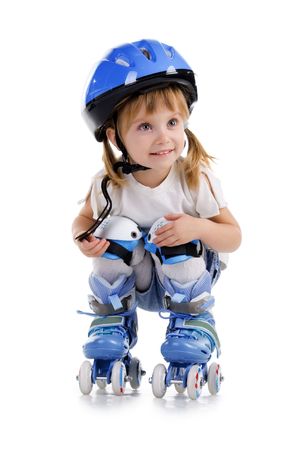 Cute girl in roller skates on a white backgroundの写真素材
