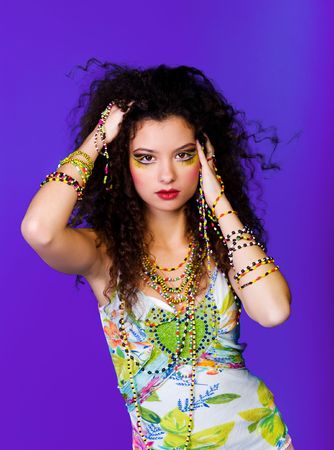 Young beautiful women with colorful beads on  blue backgroundの写真素材