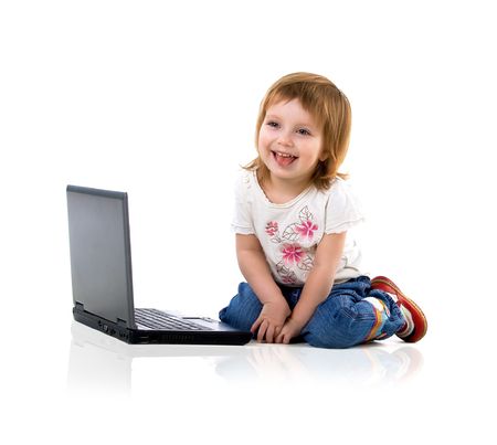 Cute little girl sit near laptop. Studio shotの写真素材