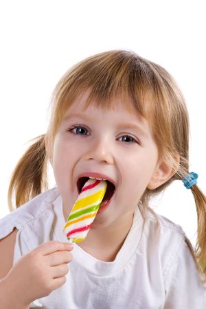 Pretty little girl with a bright lollipop. Studio shotの写真素材