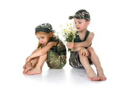 Two little soldiers with the flowers on whiteの写真素材