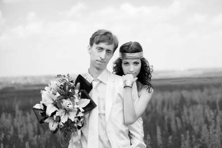 just married couple on the field. black-and-white photoの写真素材
