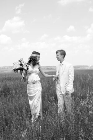just married couple on the field. black-and-white photoの写真素材