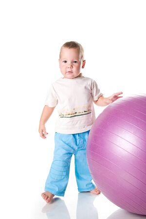 Little boy with the fitness ball on white background の写真素材