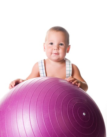 Little boy with the fitness ball on white background の写真素材