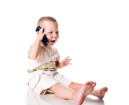 Little boy with the phone. Isolated on whiteの写真素材